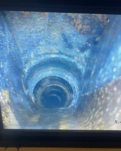 close up view of a deep pipe showing rust and corrosion revealing the interior structure plumbing inspection and maintenance